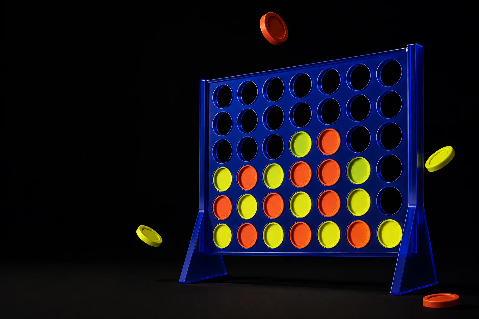 Cobalt blue Connect Four board with sculptural red and yellow discs floating in a dark studio
